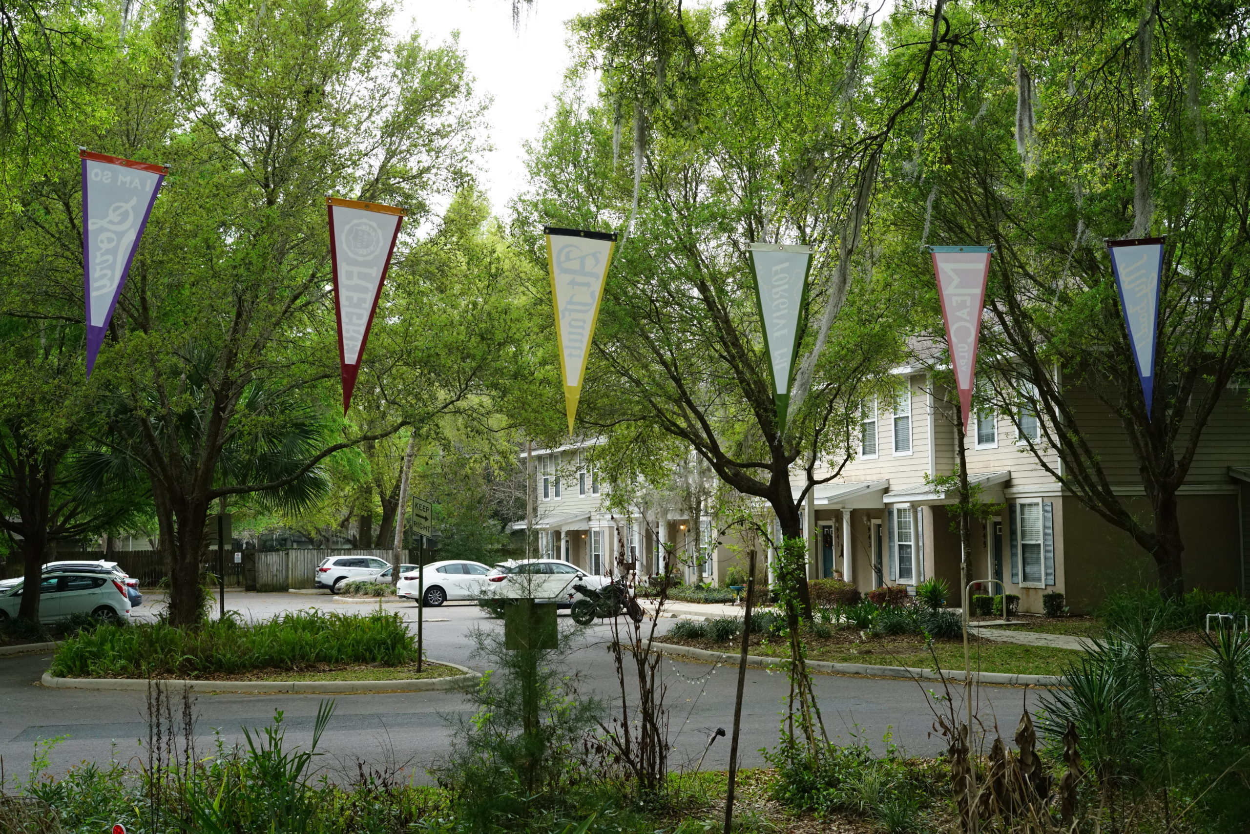 pennants hanging outside, you can see the backs of them, they face an apartment complex